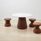 Kanju presents the Wiid Design ensemble featuring the Wiid Terrazzo and Cork Dining Table in Dark Cork accompanied by matching Dark Cork African Cork Stools. This luxurious dining set marries the unique textures of terrazzo and dark cork, reflecting an unparalleled commitment to sustainable luxury and innovative design. Perfect for those who appreciate artisan craftsmanship and eco-conscious materials in their dining spaces.