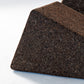 Close-up detail of Kanju's Wiid Triangle Cork Tables in Dark Cork, highlighting the material's textured elegance and the geometric precision of the design. This image captures the depth and richness of the dark cork, emphasizing the tables' sustainable craftsmanship and contemporary aesthetic, perfect for sophisticated, eco-conscious interiors.