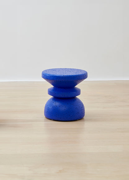 Kanju's Wiid Painted African Stacked Cork Stool in a deep blue, exemplifying a blend of modern design and sustainability. The layered cork construction is highlighted by the rich blue finish, offering a unique, eco-friendly seating solution that adds a touch of sophistication and bold color to any space.